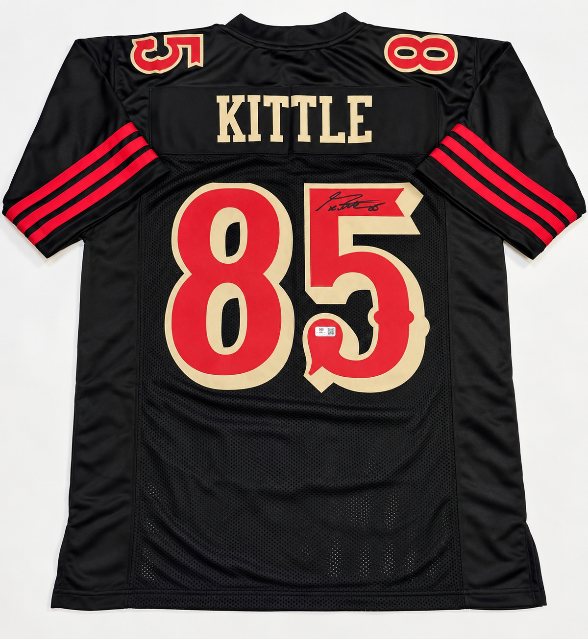 Back of George Kittle autographed black San Francisco 49ers-style number 85 jersey showing signature and authentication sticker