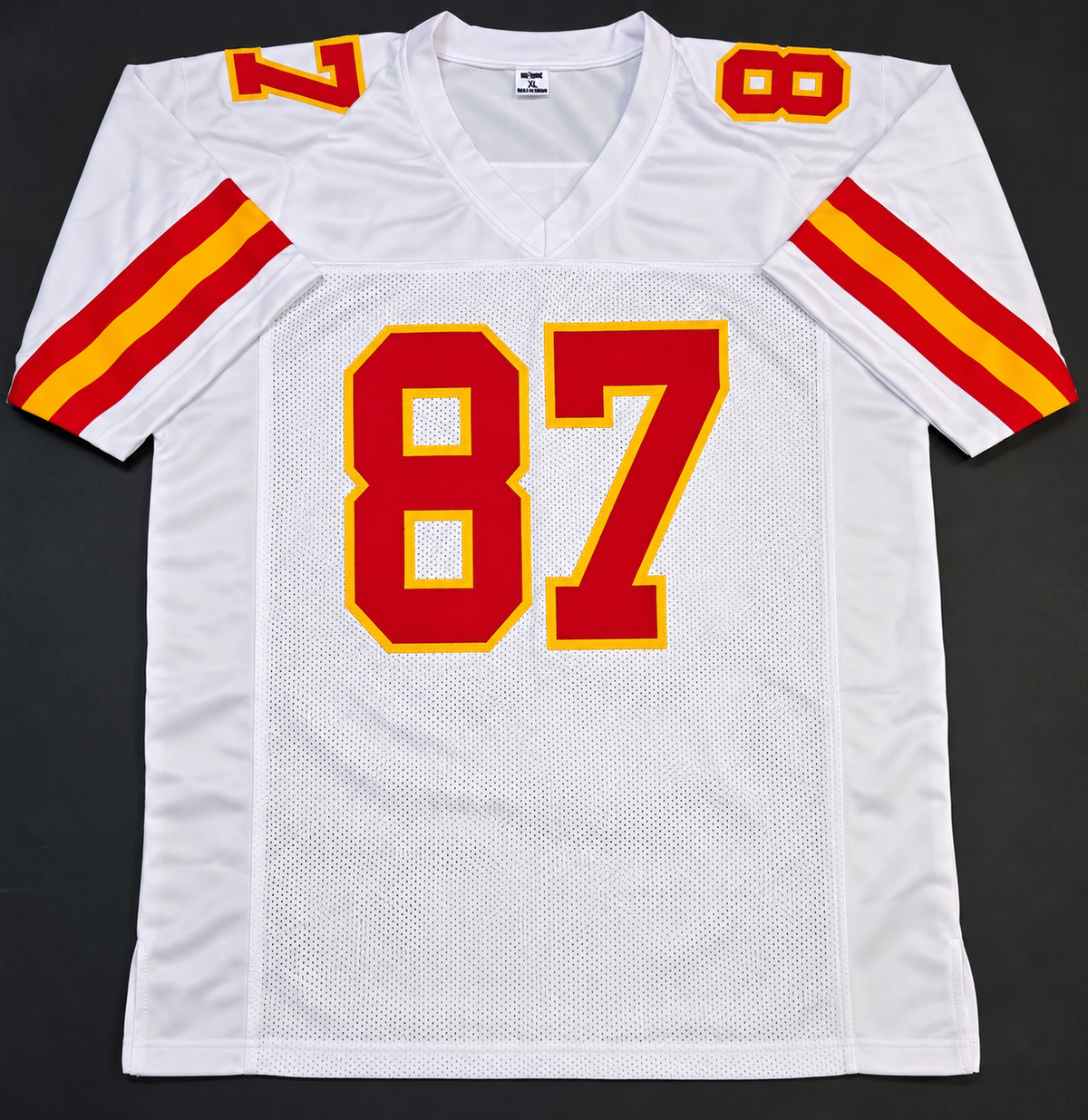 Front of white Kansas City Chiefs-style Travis Kelce number 87 football jersey with red and gold sleeve stripes