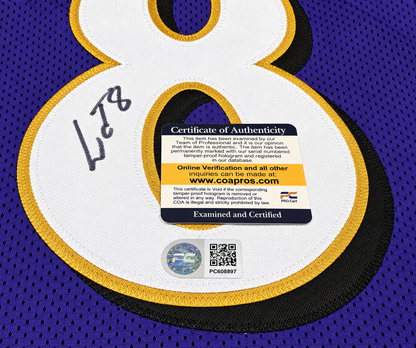 Close-up of Lamar Jackson signature on purple number 8 jersey with PRO-Cert COA card and hologram PC608897
