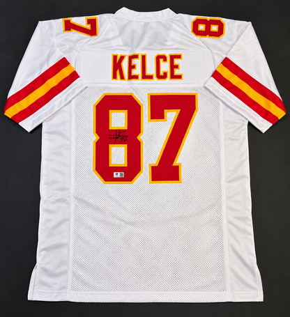 Back of white Travis Kelce Kansas City Chiefs-style autographed number 87 football jersey with signature and authentication label
