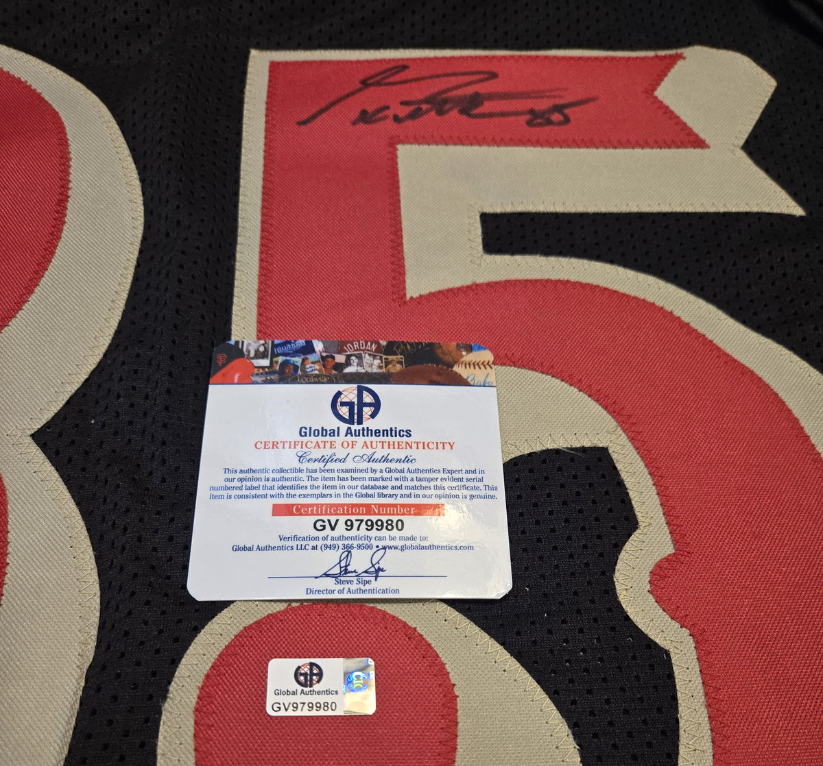 Authentication documentation photographed for George Kittle autographed black number 85 football jersey
