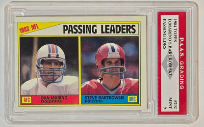 1984 Topps Passing Leaders number 202 Dan Marino and Steve Bartkowski graded PAAS Mint 9, card front